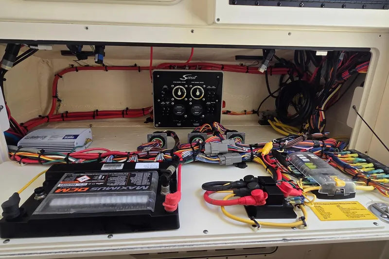 Slide: The Image of Electrical system of a 2021 Scout 305 LXF boat, featuring wiring and battery setup. - 24