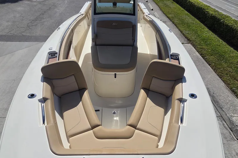 Slide: The Image of 2021 Scout 305 LXF boat with beige seating and sleek design. - 25