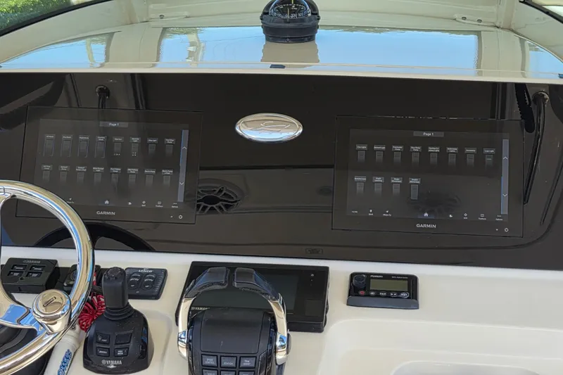 Slide: The Image of 2021 Scout 305 LXF boat dashboard with dual Garmin displays and Yamaha controls. - 27