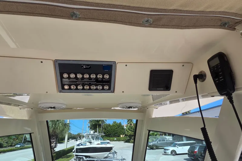 Slide: The Image of Interior view of 2021 Scout 305 LXF boat dashboard with control panel and radio. - 33