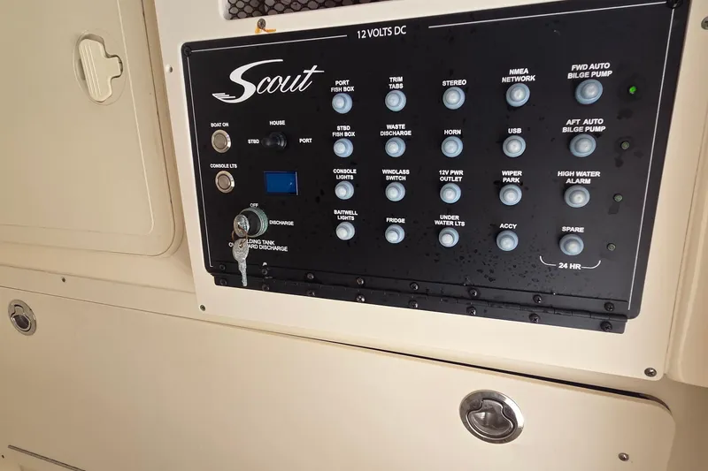 Slide: The Image of 2021 Scout 305 LXF control panel with various switches and indicators. - 9