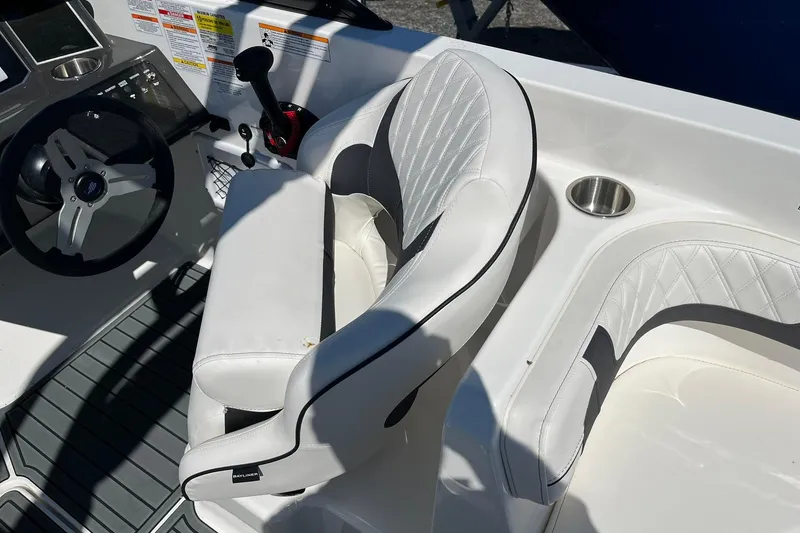 Slide: The Image of Interior of 2026 Bayliner VR6 Bowrider OB with white seating and steering wheel. - 12