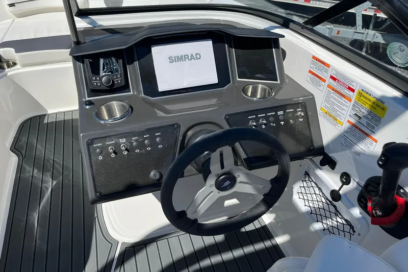 Slide: The Image of 2026 Bayliner VR6 Bowrider OB dashboard with steering wheel and control panel. - 13
