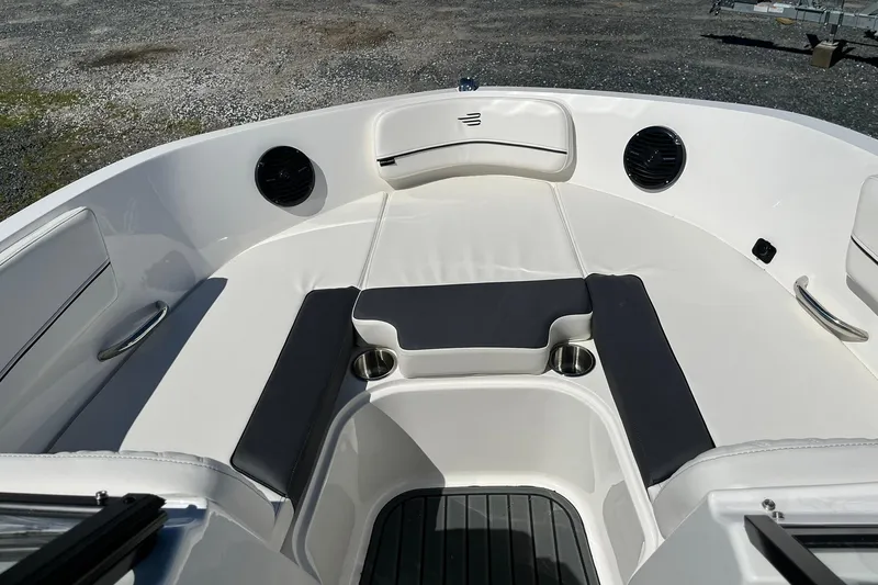 Slide: The Image of 2026 Bayliner VR6 Bowrider OB interior with cushioned seating and cup holders. - 16