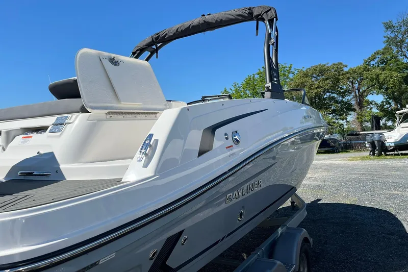 Slide: The Image of 2026 Bayliner VR6 Bowrider OB boat on trailer, sunny day, outdoor setting. - 6