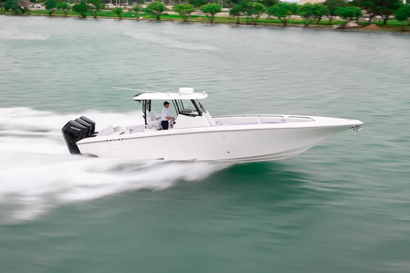 The Image of 2025 Fountain 38 Center Console speeding on water, showcasing sleek design and powerful engines. - 1