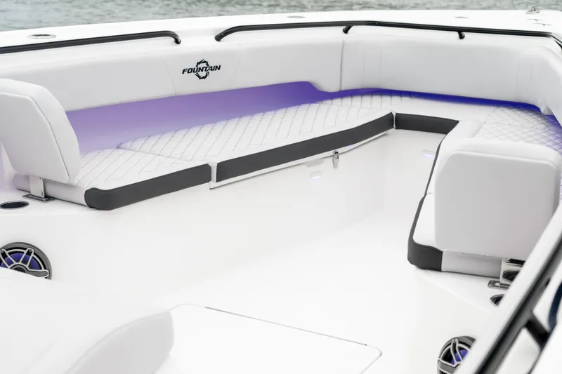 Slide: The Image of 2025 Fountain 38 Center Console boat interior with white seating and ambient lighting. - 12