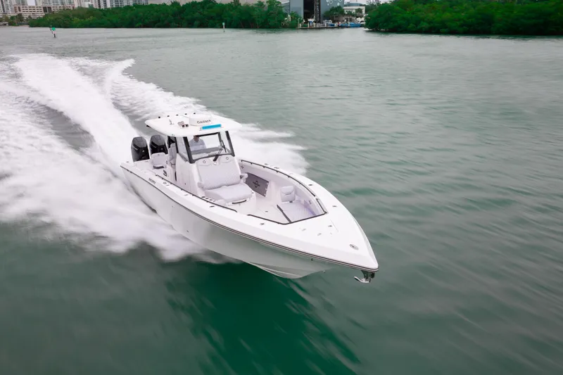 Slide: The Image of 2025 Fountain 38 Center Console boat cruising on a calm waterway. - 4