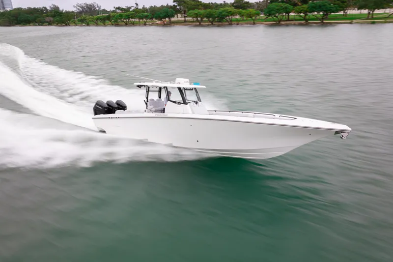 Slide: The Image of 2025 Fountain 38 Center Console boat speeding on water, showcasing sleek design and powerful engines. - 5