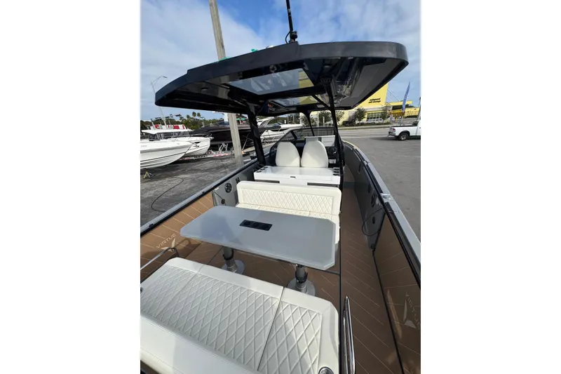 Slide: The Image of 2026 Virtue V10 boat with dual engines on calm water, city skyline in background. - 105