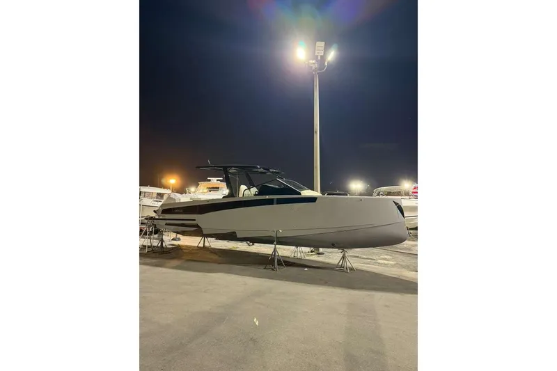 Slide: The Image of Modern 2026 Virtue V10 boat on calm water under cloudy sky. - 107