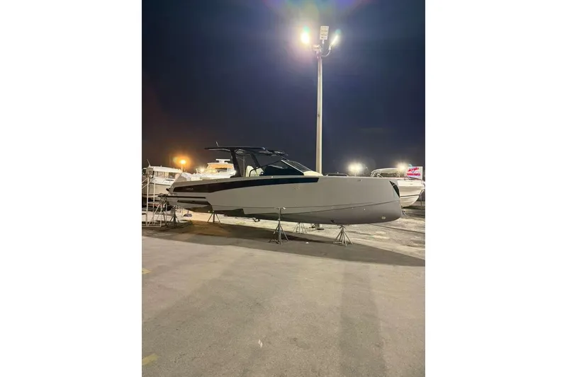 Slide: The Image of 2026 Virtue V10 boat on calm water, featuring sleek design and dual outboard motors. - 110