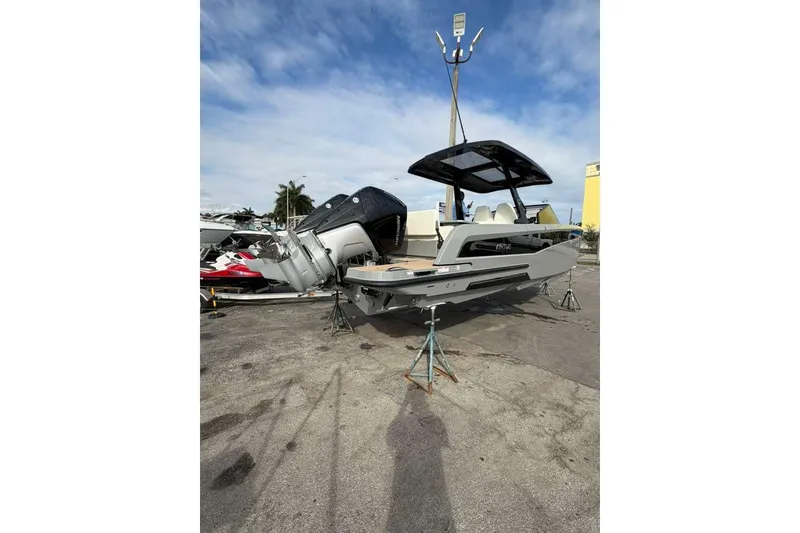 Slide: The Image of 2026 Virtue V10 boat cruising on a calm waterway with dual outboard engines. - 112