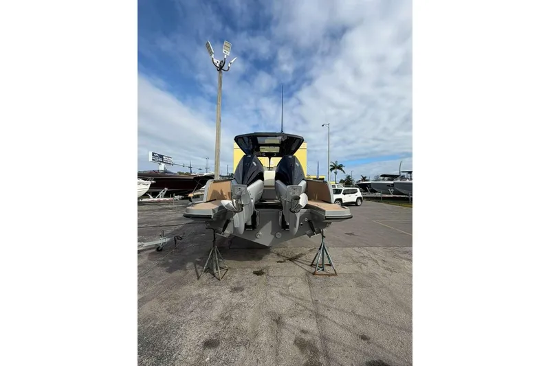 Slide: The Image of 2026 Virtue V10 boat cruising on a calm waterway with cityscape in background. - 113