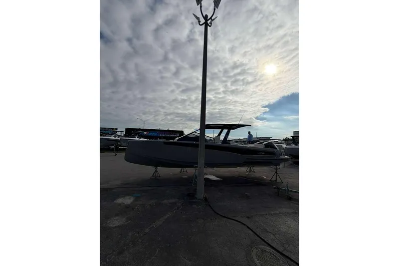 Slide: The Image of 2026 Virtue V10 boat on calm water under cloudy sky. - 116