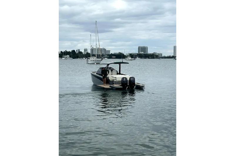 Slide: The Image of Modern 2026 Virtue V10 boat on calm waters with cityscape background. - 120