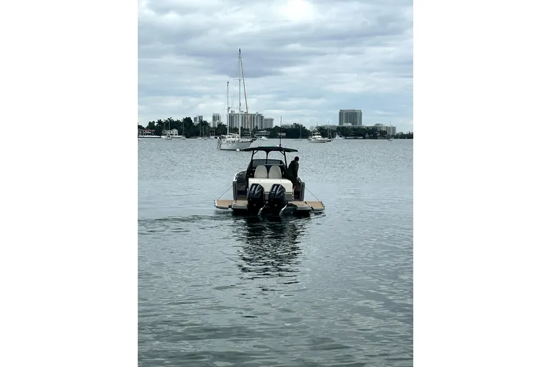 Slide: The Image of 2026 Virtue V10 boat on calm water with cityscape background. - 121