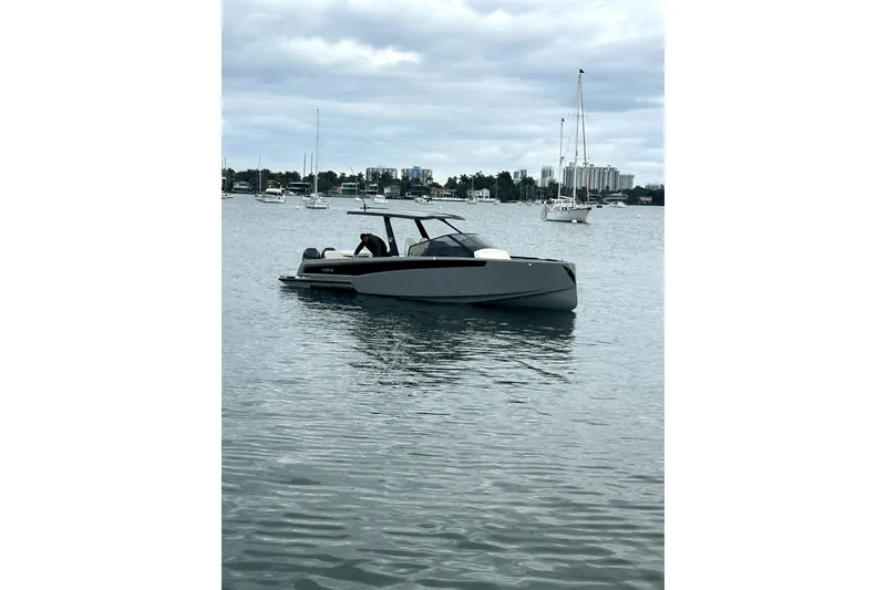 Slide: The Image of Modern 2026 Virtue V10 boat on calm water with cityscape background. - 122