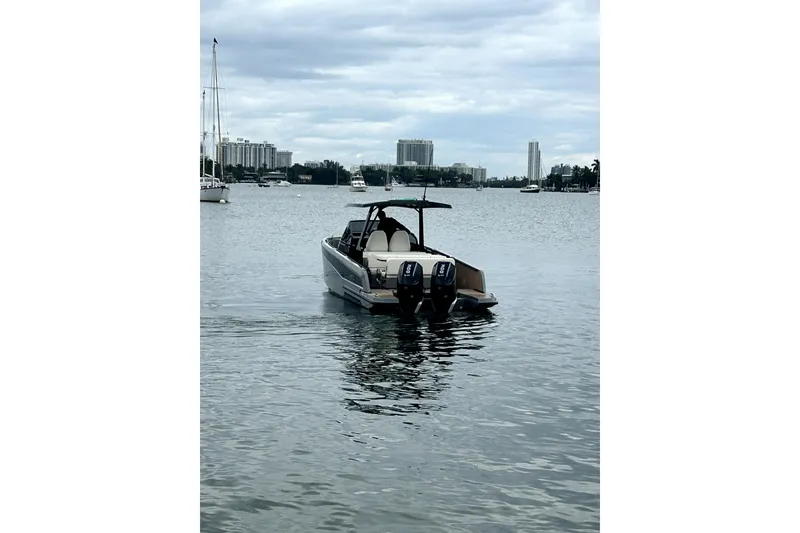 Slide: The Image of 2026 Virtue V10 boat on calm water with cityscape background. - 126