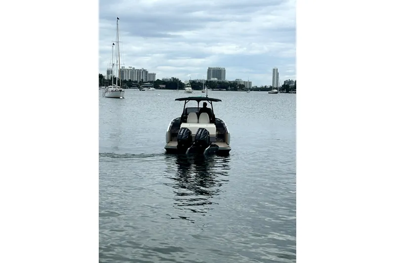Slide: The Image of 2026 Virtue V10 boat on calm water with city skyline in background. - 127