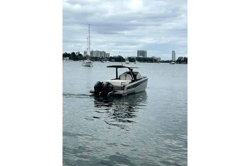 Slide: The Image of 2026 Virtue V10 boat on calm water with city skyline in background. - 128