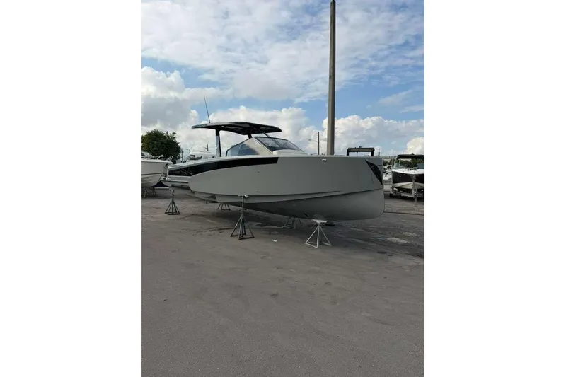 Slide: The Image of 2026 Virtue V10 boat on stands under a partly cloudy sky. - 137