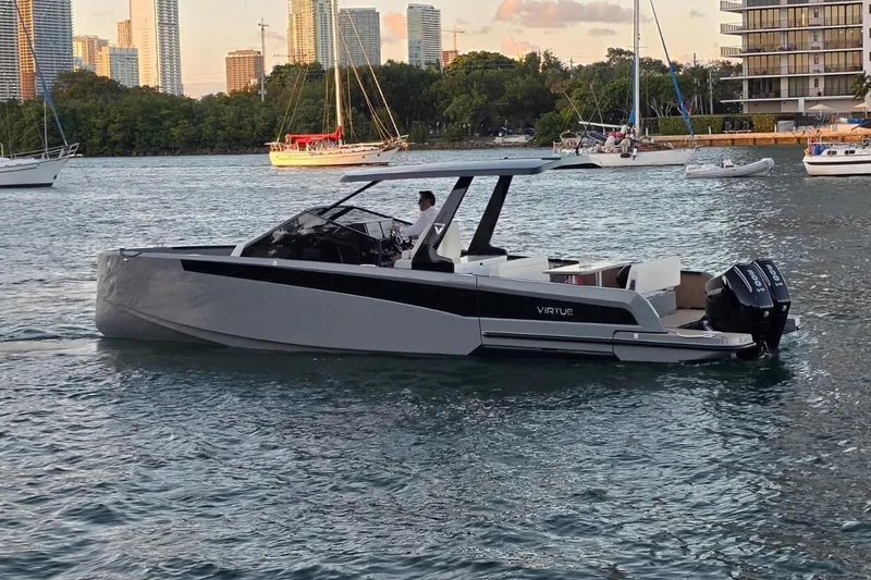 Slide: The Image of 2026 Virtue V10 boat displayed outdoors under clear blue sky. - 22