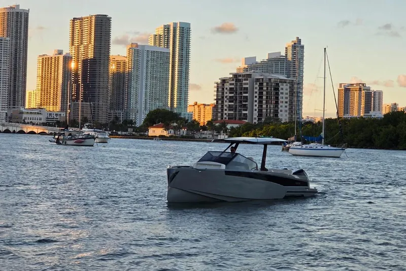 Slide: The Image of 2026 Virtue V10 boat on water with city skyline in background. - 23