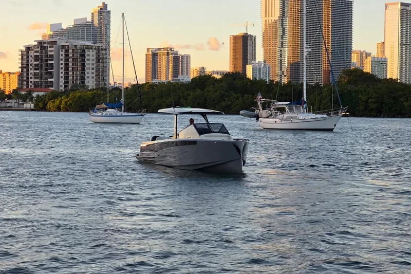 Slide: The Image of 2026 Virtue V10 luxury boat cruising on a scenic waterfront with city skyline. - 26
