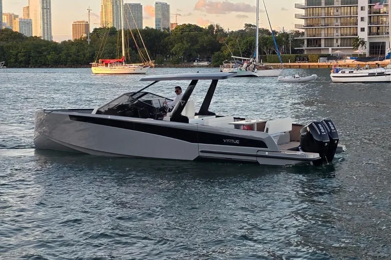 Slide: The Image of Covered 2026 Virtue V10 boat on stands, outdoor marina setting. - 33