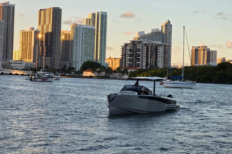 Slide: The Image of 2026 Virtue V10 boat displayed outdoors at night under bright lights. - 36