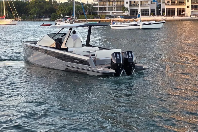 Slide: The Image of 2026 Virtue V10 boat with dual engines on calm water under cloudy sky. - 39