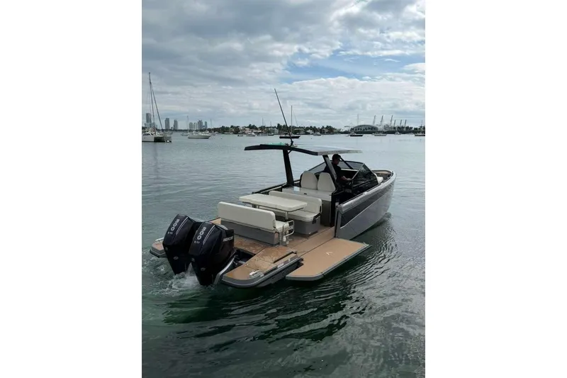 Slide: The Image of 2026 Virtue V10 boat on water, featuring sleek design and dual Mercury engines. - 44