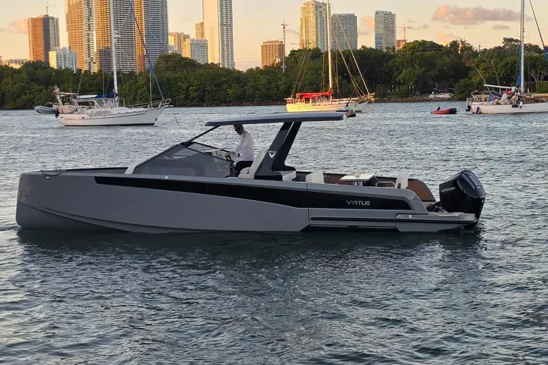 Slide: The Image of Virtue V10 2026 boat on calm water under cloudy sky. - 53