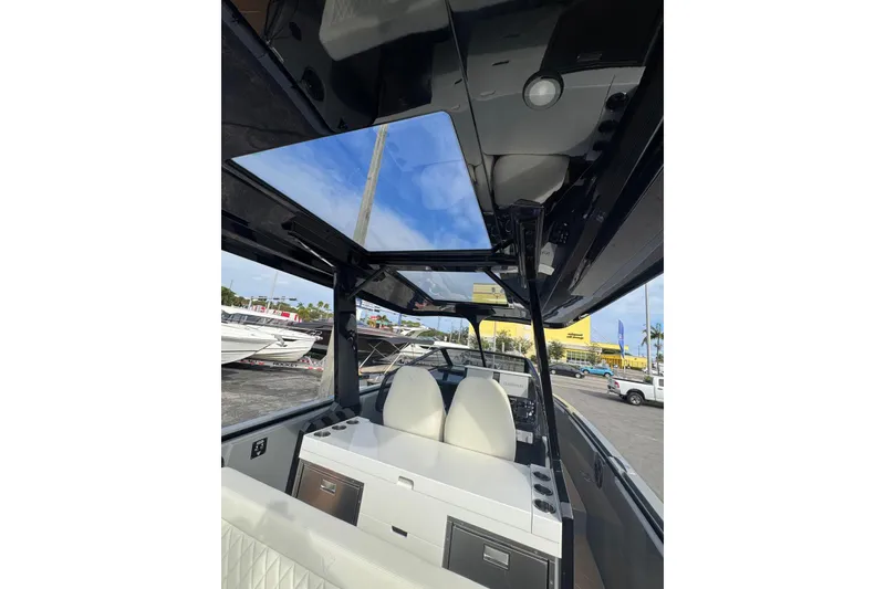 Slide: The Image of 2026 Virtue V10 boat cruising on calm waters under a cloudy sky. - 64