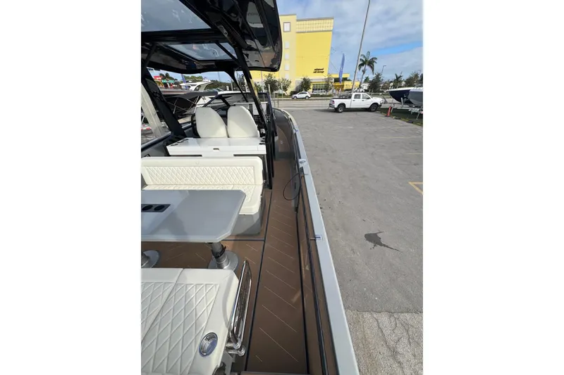 Slide: The Image of 2026 Virtue V10 boat on calm water with city skyline in background. - 65