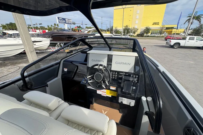 Slide: The Image of Virtue V10 2026 boat with dual engines on calm water, scenic marina backdrop. - 66