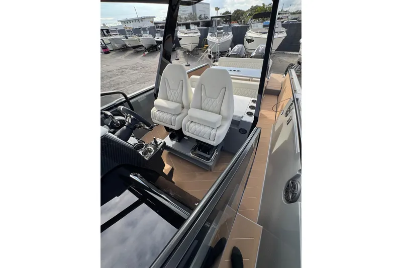 Slide: The Image of 2026 Virtue V10 boat on water, featuring sleek design and dual Mercury engines. - 70