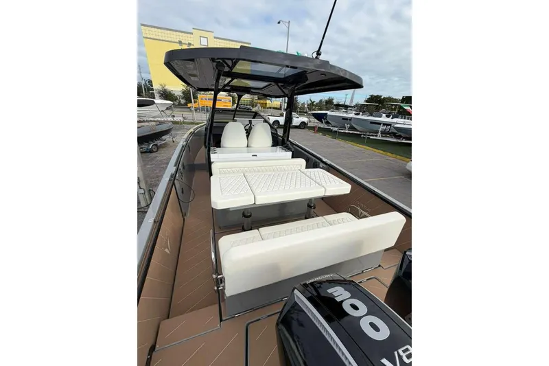 Slide: The Image of Interior view of 2026 Virtue V10 boat cockpit with white seating and steering wheel. - 88