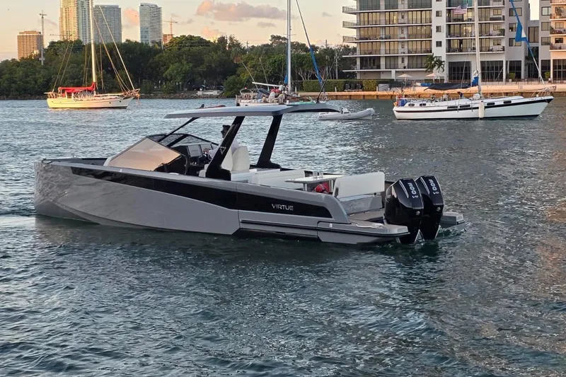 Slide: The Image of 2026 Virtue V10 boat on calm water with dual outboard motors. - 9