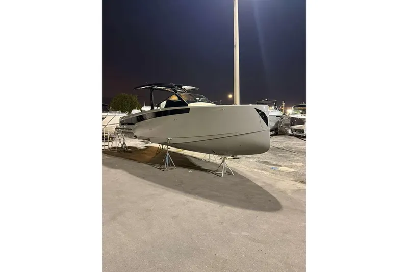 Slide: The Image of 2026 Virtue V10 boat on calm water with city skyline in background. - 93