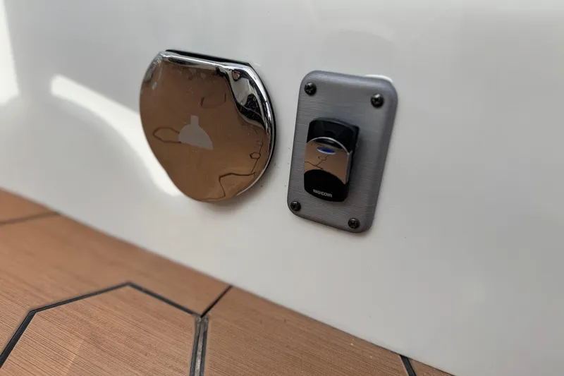 Slide: The Image of Close-up of 2022 South Bay 25 Sport RS9-DC boat's washdown switch and chrome cover. - 14
