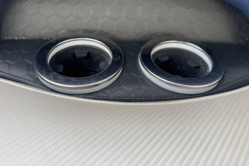 Slide: The Image of Close-up of dual cup holders in a 2022 South Bay 25 Sport RS9-DC boat. - 19