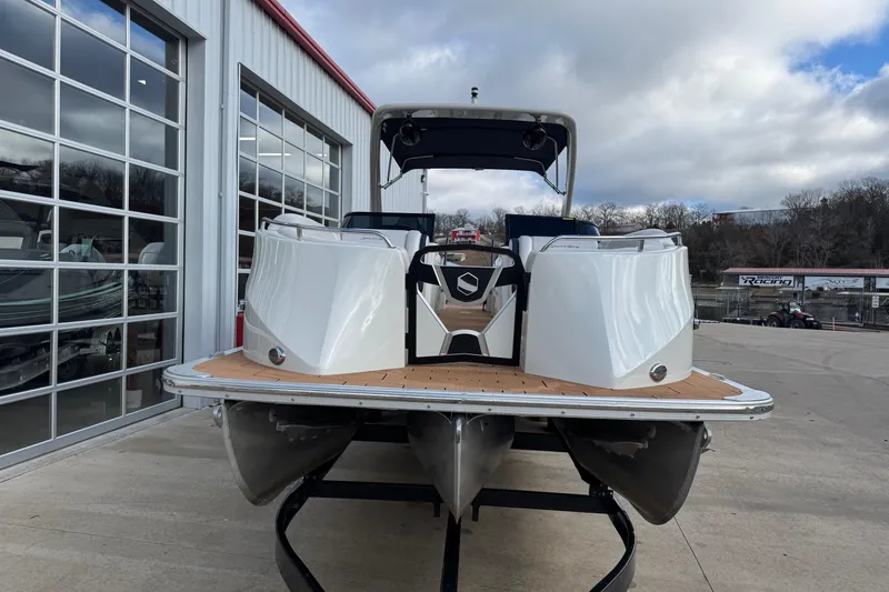 Slide: The Image of 2022 South Bay 25 Sport RS9-DC pontoon boat at a marina, showcasing sleek design. - 2