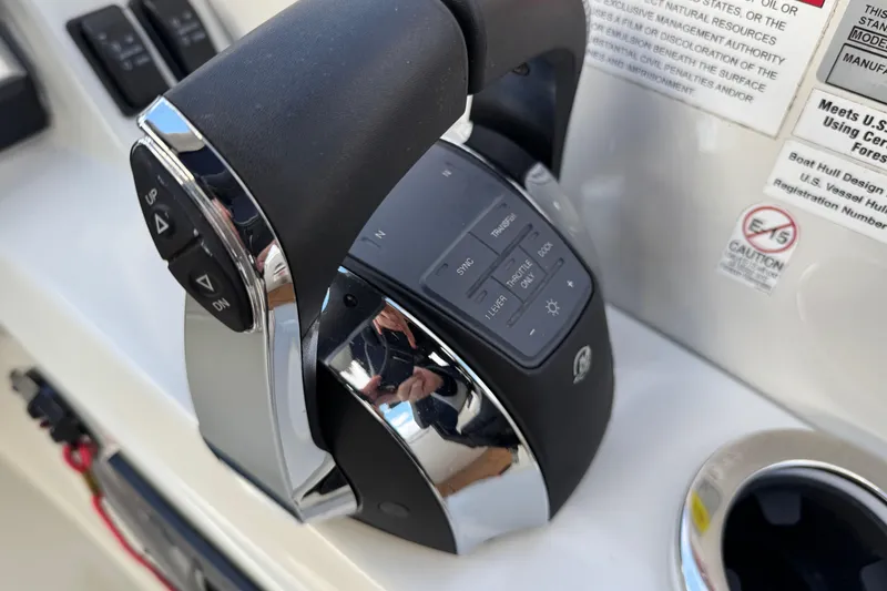 Slide: The Image of Close-up of 2022 South Bay 25 Sport RS9-DC boat throttle control panel. - 26