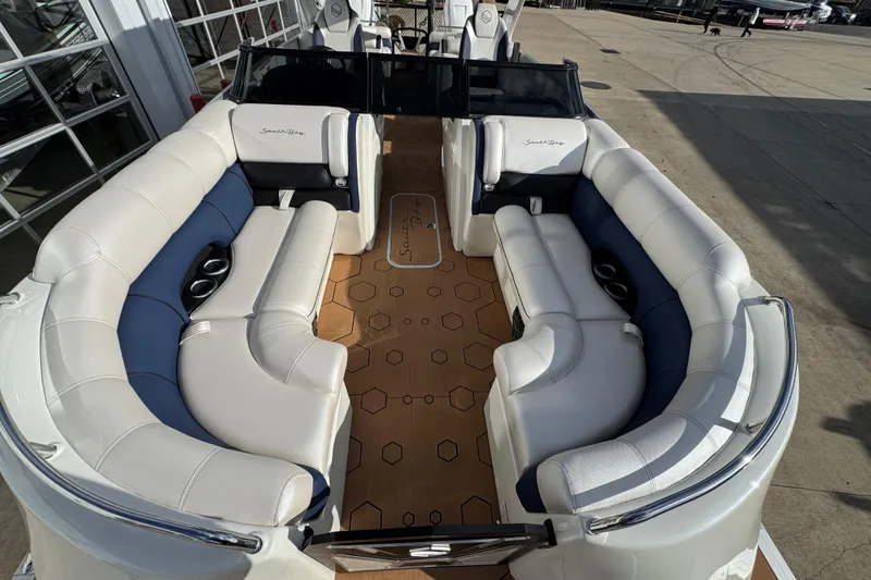 Slide: The Image of 2022 South Bay 25 Sport RS9-DC boat interior with white and blue seating. - 35