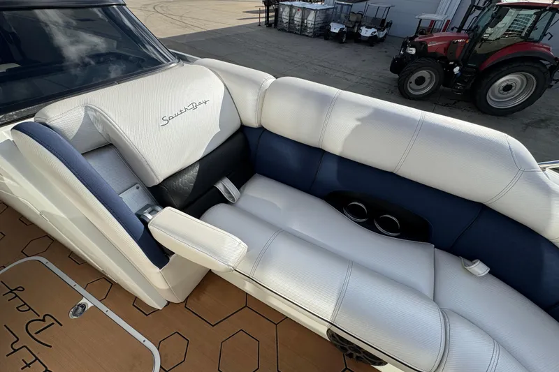Slide: The Image of Luxurious seating on 2022 South Bay 25 Sport RS9-DC boat, featuring white and blue upholstery. - 36