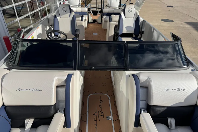 Slide: The Image of 2022 South Bay 25 Sport RS9-DC boat interior with white and blue seating. - 37