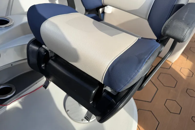 Slide: The Image of Captain's chair on 2022 South Bay 25 Sport RS9-DC boat, featuring blue and beige upholstery. - 40