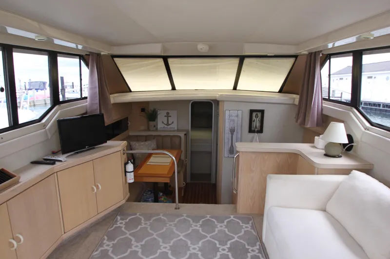 Slide: The Image of Interior of a 1990 Silverton 34 Convertible yacht with cozy seating and nautical decor. - 11